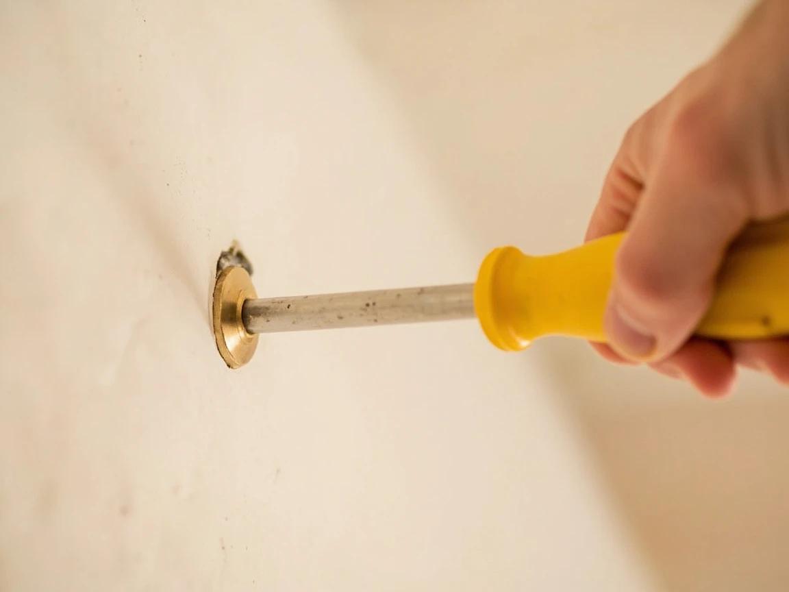 Step 5 of How to Install Drywall Anchors for Heavy Items (TV, Mirror, Shelf): Install the anchor flush — method depends on type