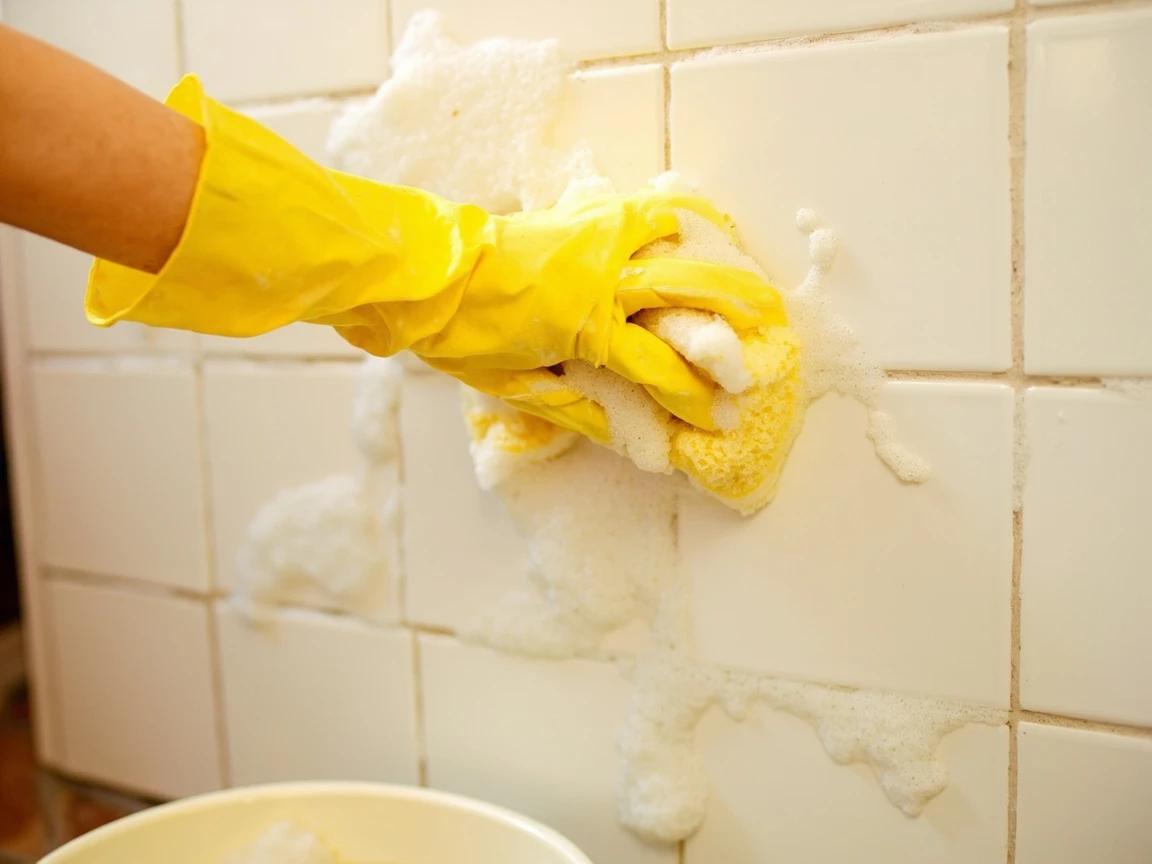 Step 2 of How to Clean and Seal Bathroom Grout: Strip the surface film with soapy water
