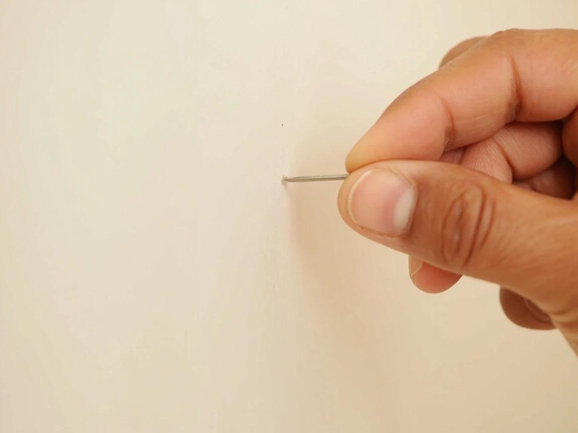 Step 8 of How to Find a Stud Without a Stud Finder: Confirm with a thin nail before you commit