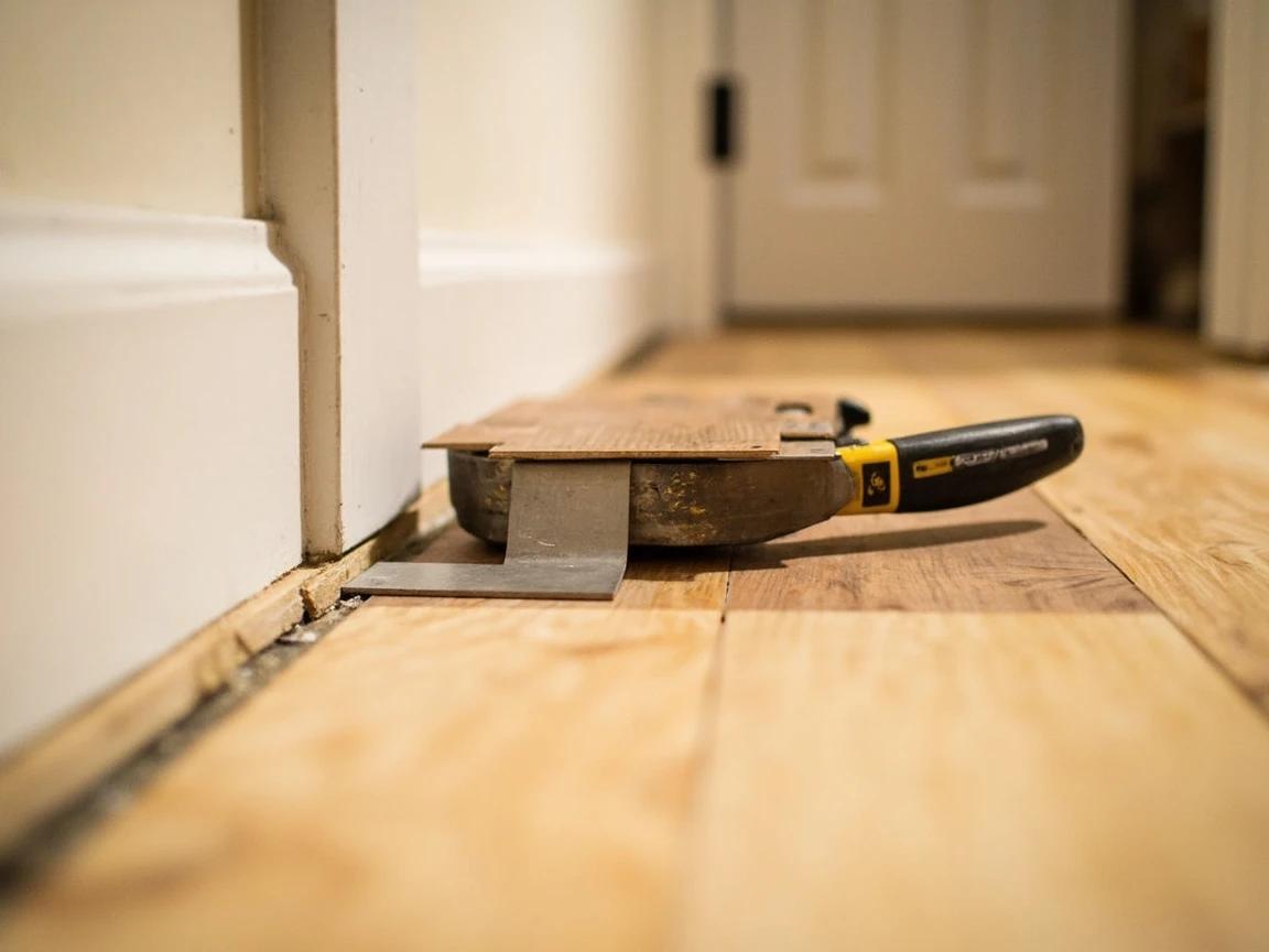 Step 7 of How to Install Laminate Flooring: Cut Around Door Jambs, Pipes, and Corners